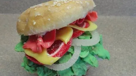 A colorful sandwich with layers of lettuce, cheese, and various toppings.
