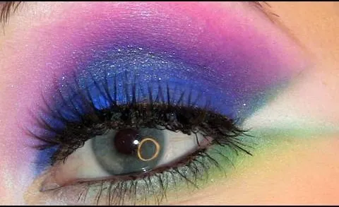 Vibrant eye makeup with shades of pink, purple, and blue.