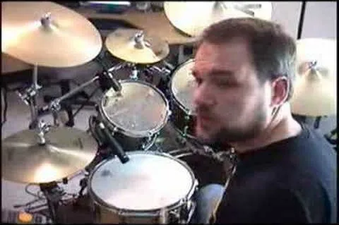 Man playing drums in a studio setting.