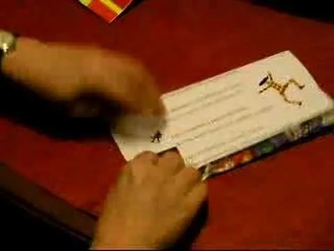 Hands holding a colorful letter with a giraffe illustration.