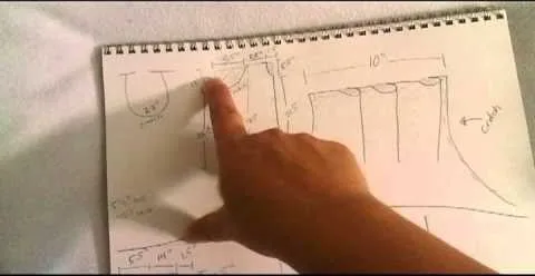 Sketch of a design with measurements and annotations on paper.
