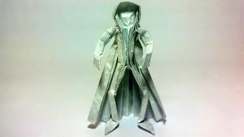 Origami figure of a cloaked character.