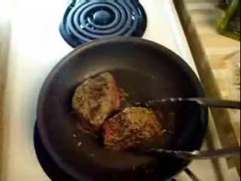 Cooking steak in a frying pan.