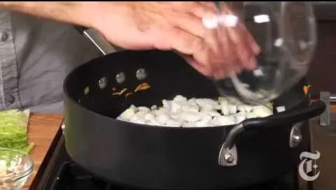 Chopping onions in a frying pan.