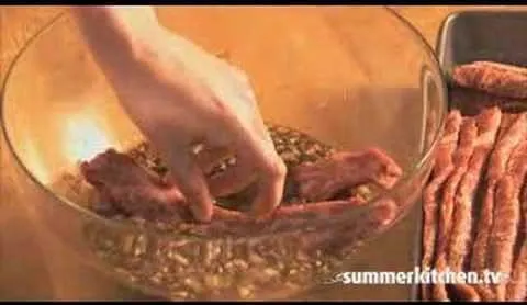 Marinating meat in a bowl with spices and herbs.