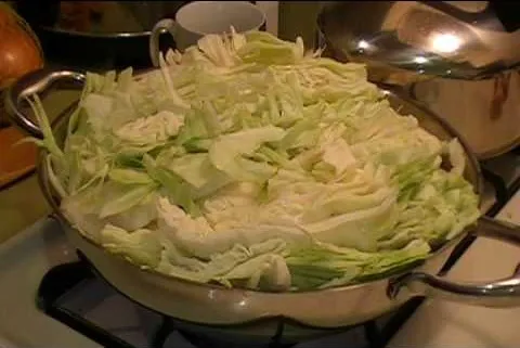 Chopped cabbage in a frying pan ready for cooking.
