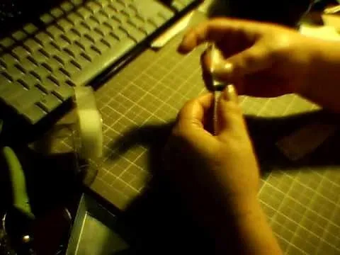 Person using crafting materials on a workspace.