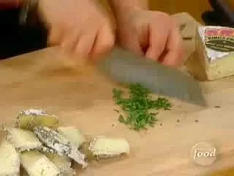 Chopping herbs on a wooden cutting board.