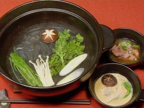 Hot pot with fresh vegetables and mushrooms, served with dipping sauces.
