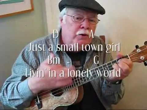 Man playing the ukulele and singing lyrics.