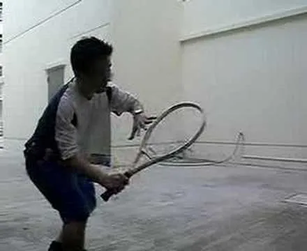 A player prepares to hit a tennis ball with a racket.