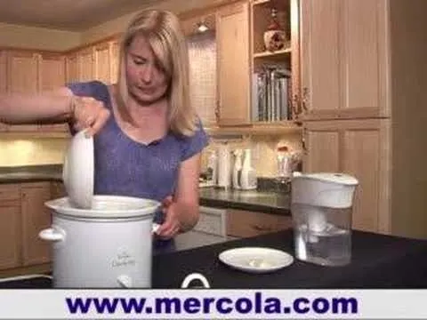 Woman cooking in a kitchen using a slow cooker.