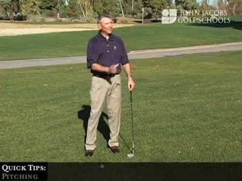 Golf instructor demonstrating a pitching technique on a course.
