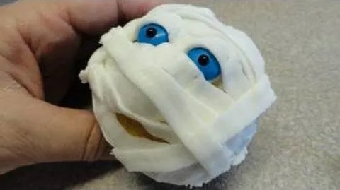 Mummy-themed Halloween decoration with blue eyes.