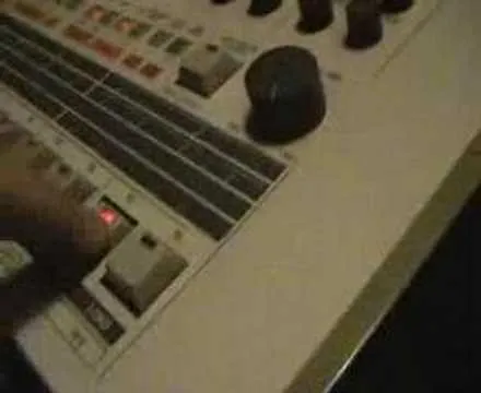 Vintage drum machine with illuminated controls.