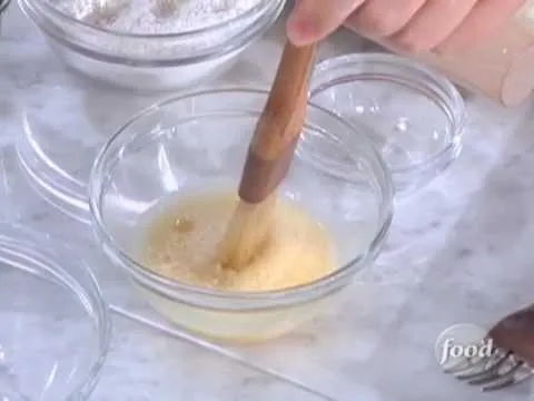 Whisking ingredients in a glass bowl.