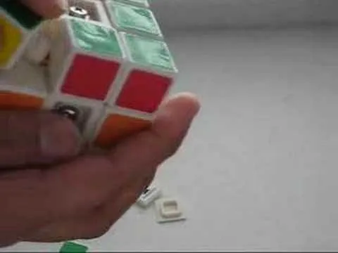 A person holding a partially solved Rubik's Cube.
