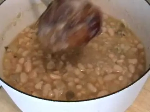 Bowl of white bean soup being stirred.