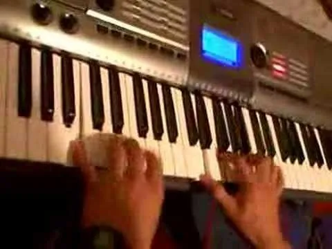 Hands playing a keyboard instrument.