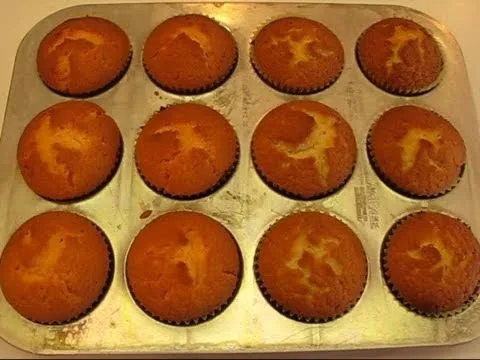 Freshly baked muffins in a metal tray.