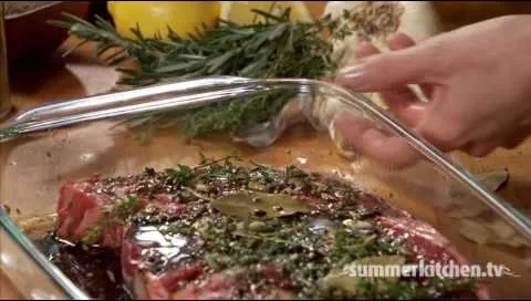 Beef marinated with herbs and spices, prepared for cooking.