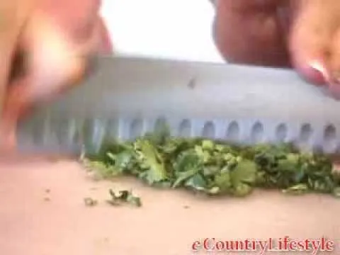 Chopped herbs on a cutting board.