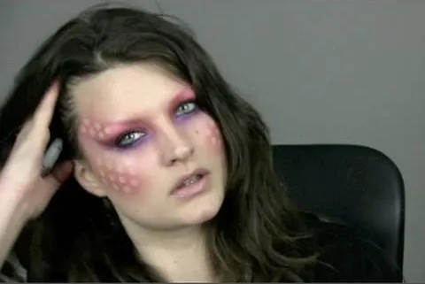 Artistic makeup design with vibrant colors and intricate patterns.