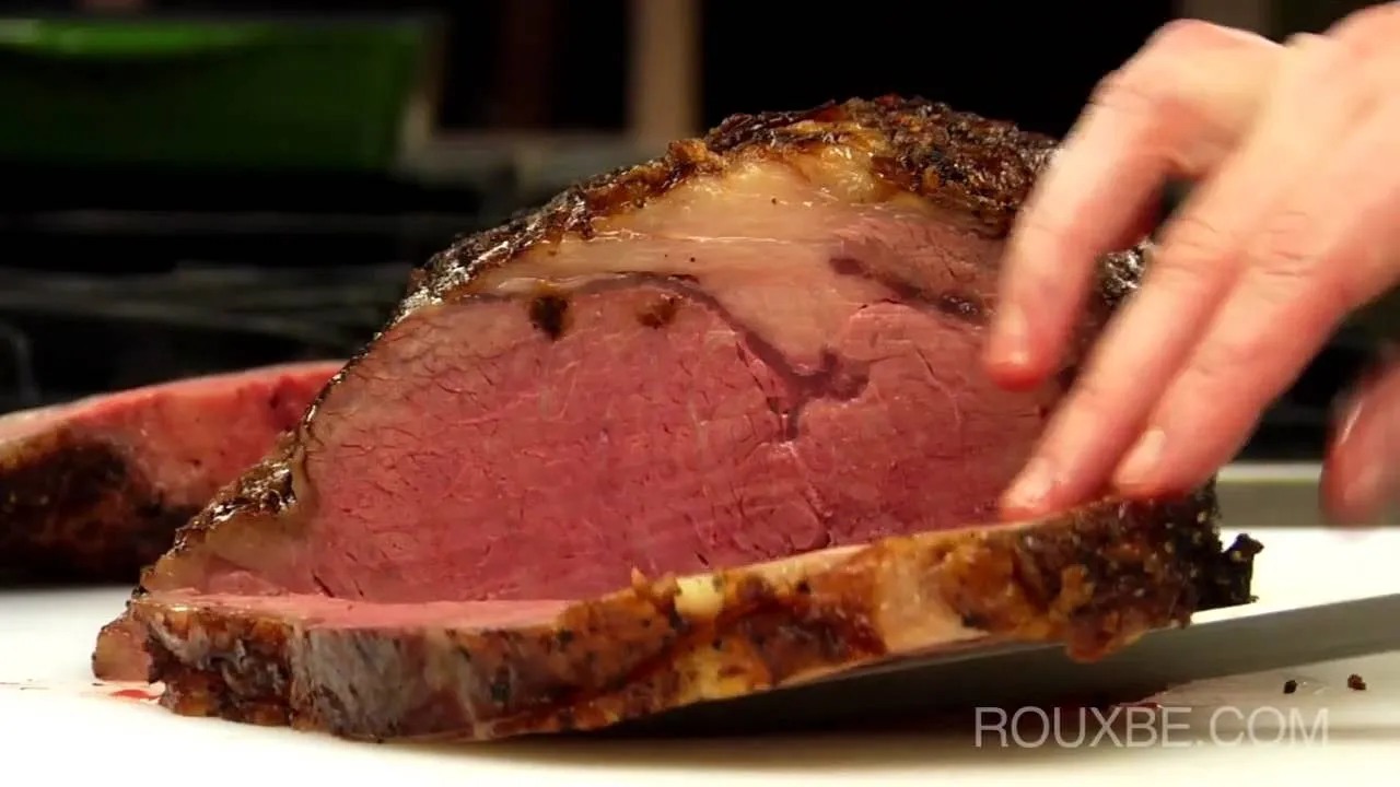 Sliced medium-rare roast beef with a crispy outer layer.
