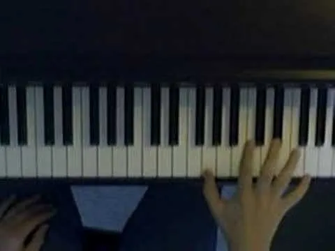 Person playing a piano keyboard.
