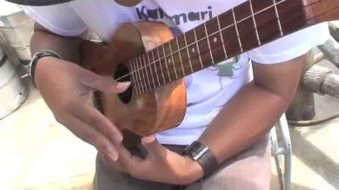 Person playing an ukulele.