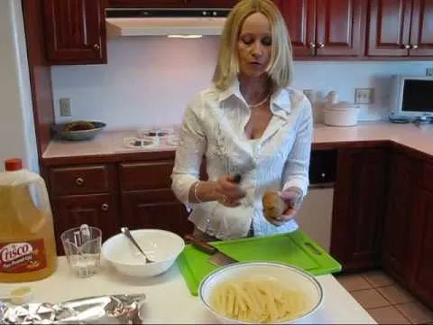 A woman preparing food in a modern kitchen.