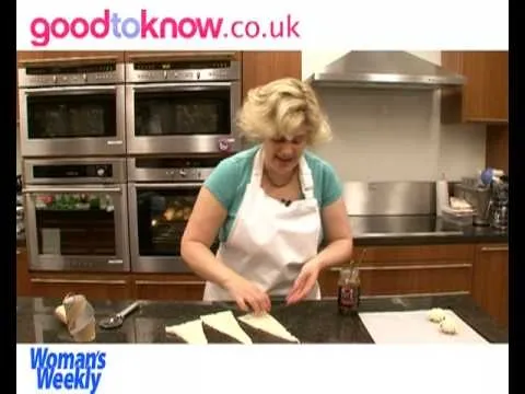 Woman preparing food in a modern kitchen.
