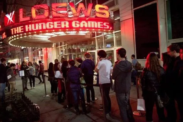 A crowd waiting in line outside a movie theater for a screening of "The Hunger Games."