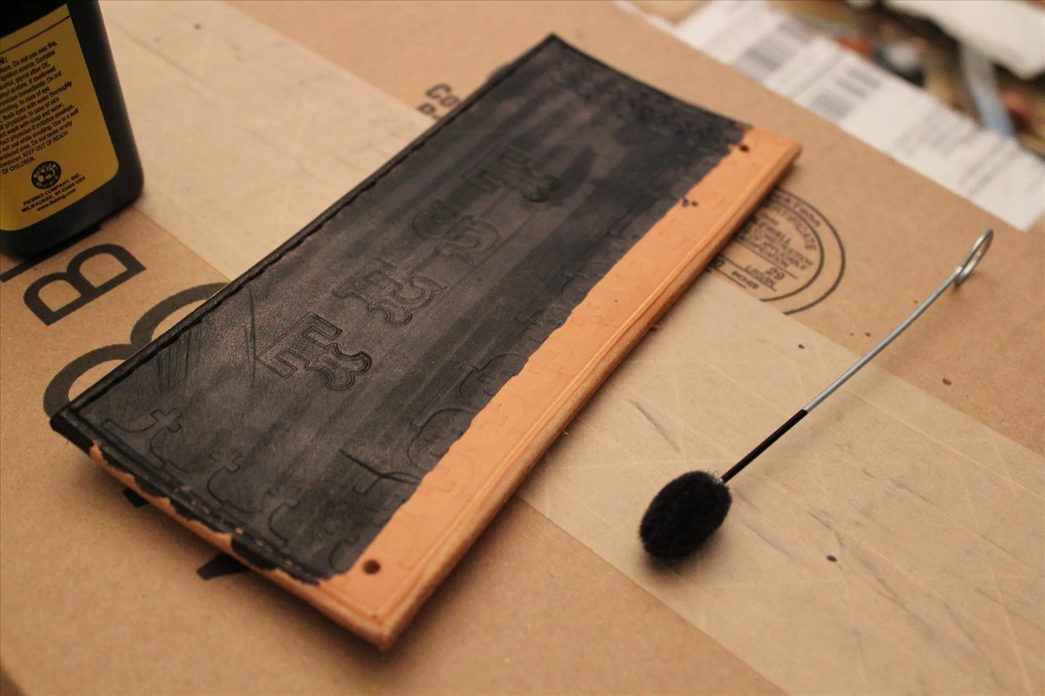 Chalkboard on a wooden surface with a chalk applicator.