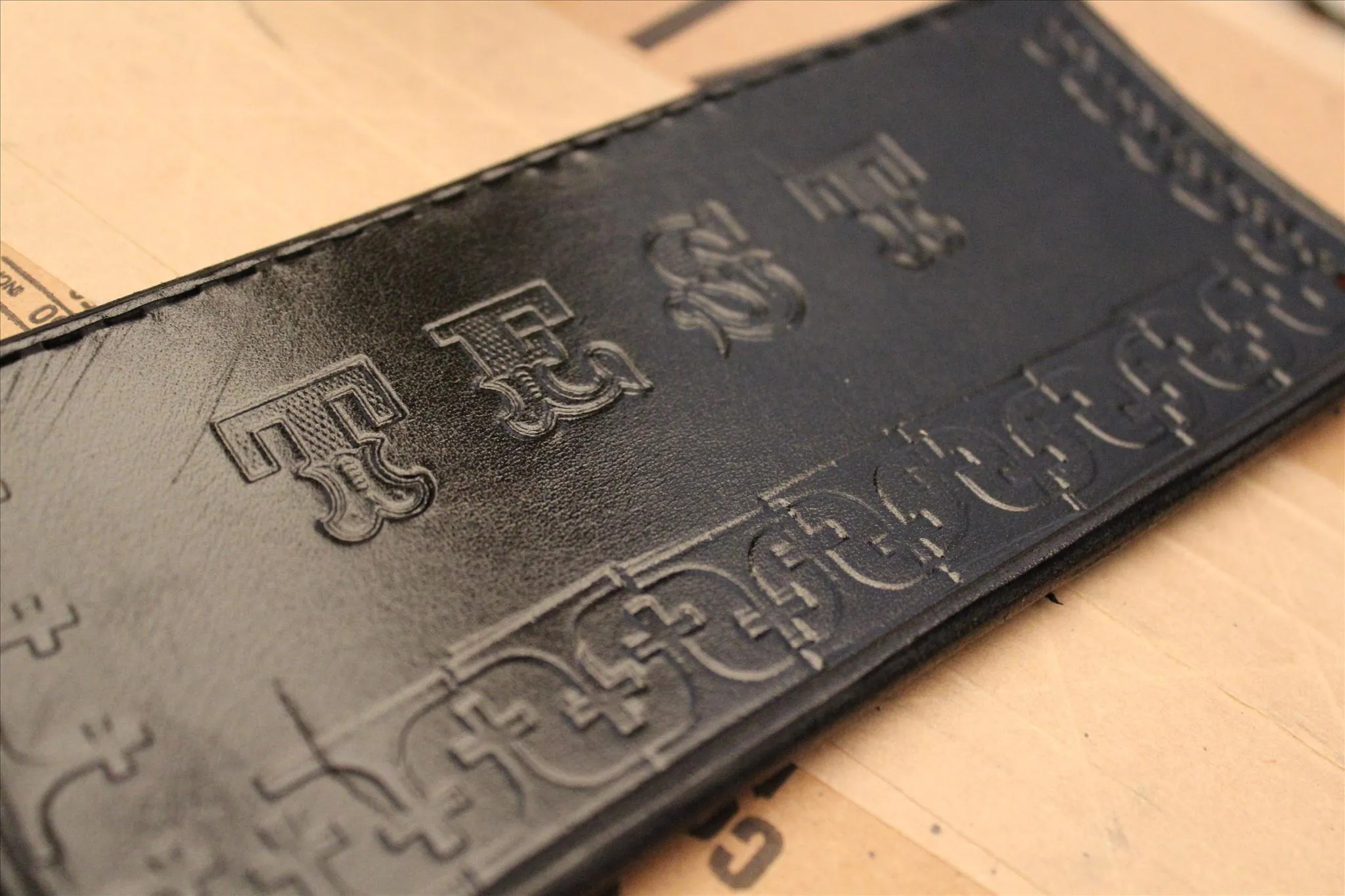 Leather wallet with embossed design.