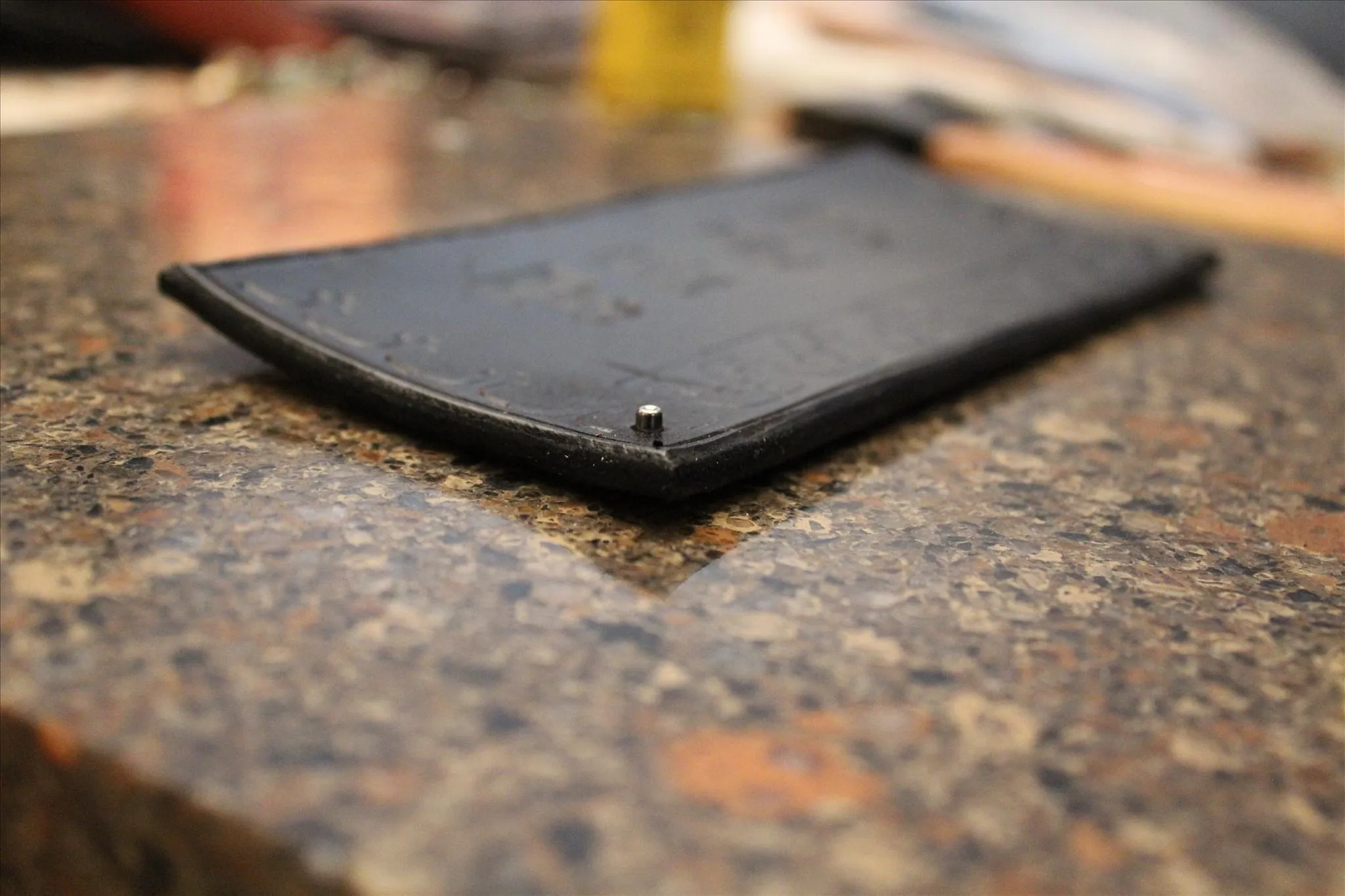 Leather wallet on a polished granite surface.