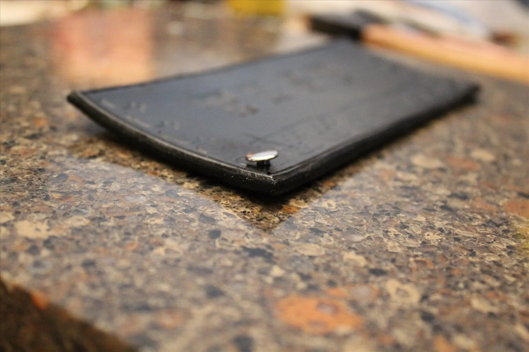 Leather wallet on a granite surface.