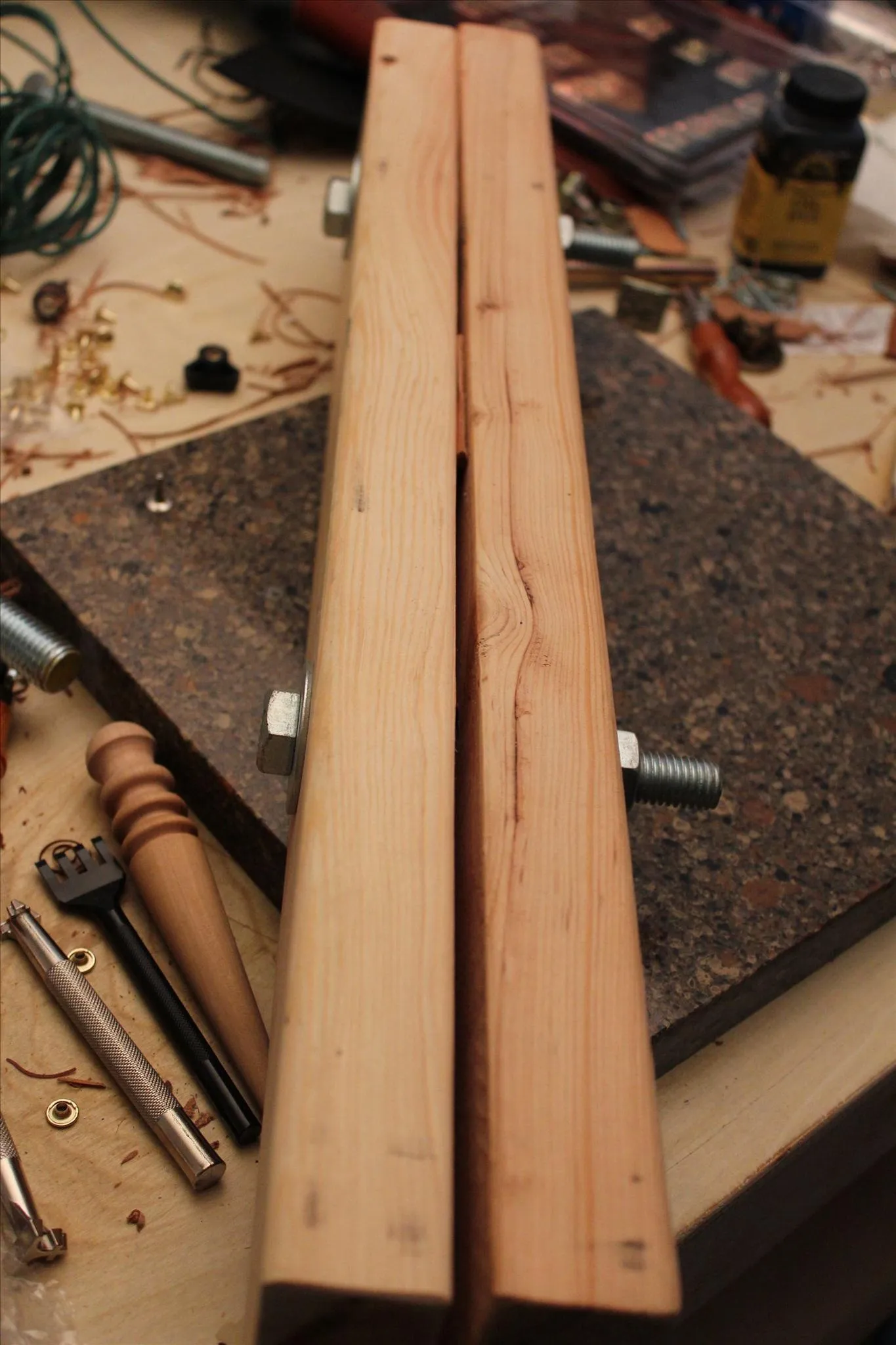 Wood pieces clamped for woodworking preparation.