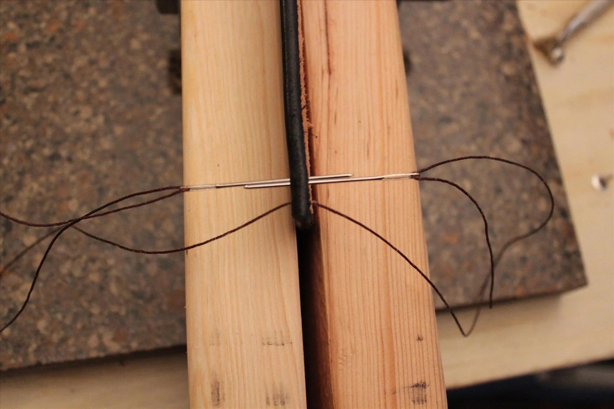 Wire tied around two wooden pieces.