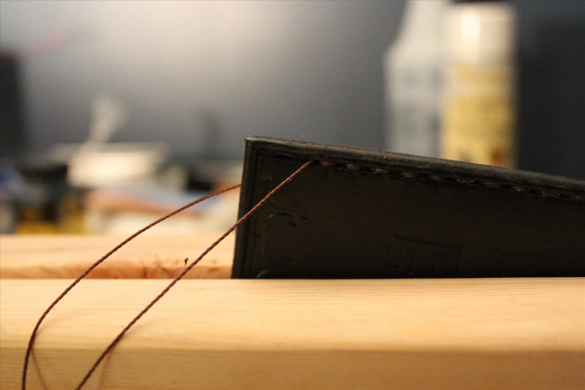 Woodworking tool with a metal blade resting on a wooden surface.