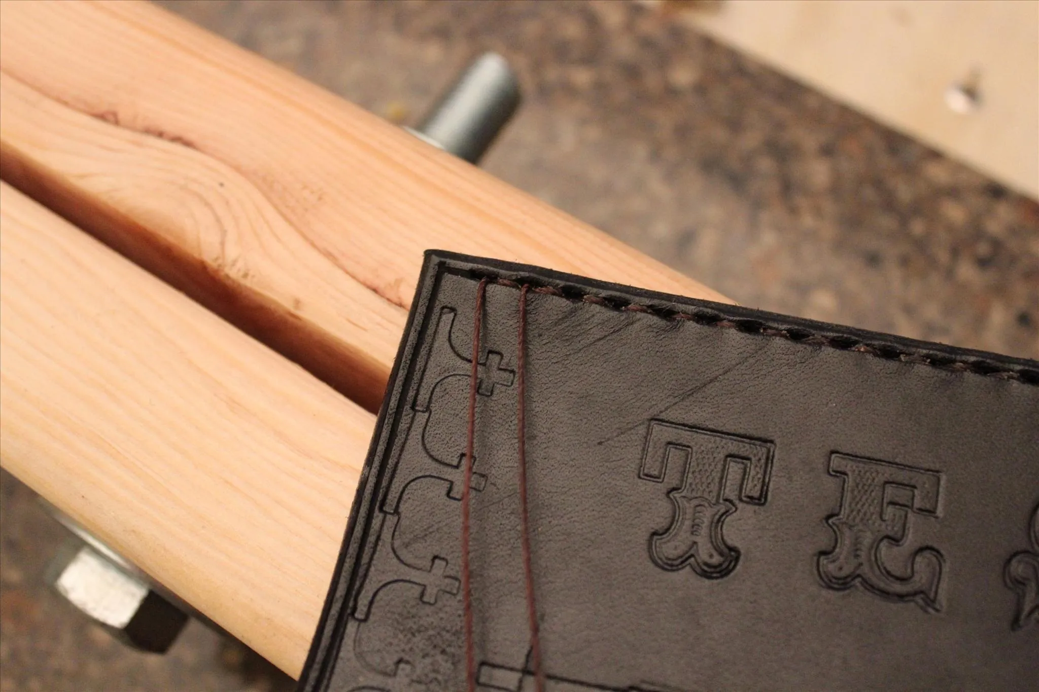 Leather wallet resting on a wooden surface.