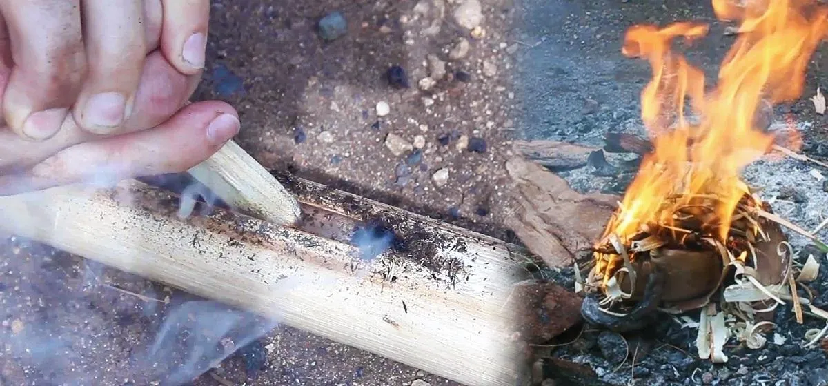 Fire-making process using a stick and kindling.