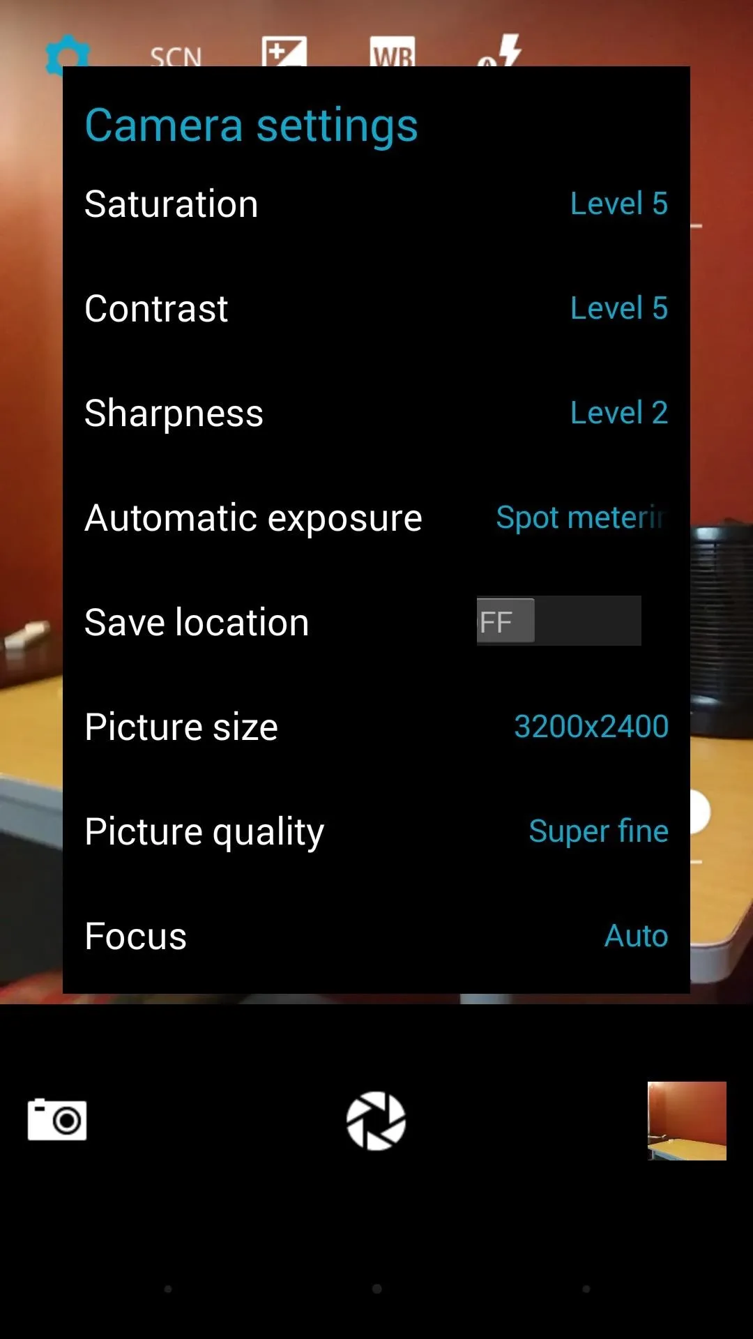 Camera settings menu with options for saturation, contrast, sharpness, exposure, location, picture size, quality, and focus.