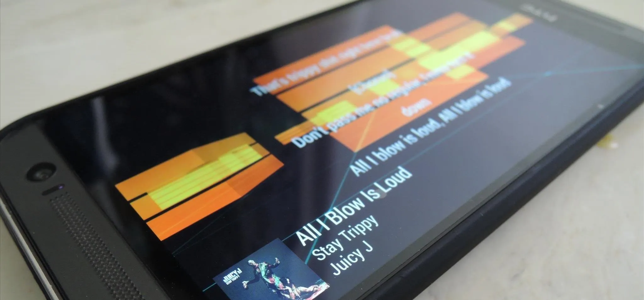 Music player displaying the song "All I Blow Is Loud" on a smartphone screen.