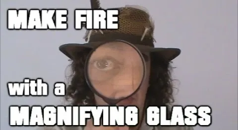 Person demonstrating how to make fire using a magnifying glass.