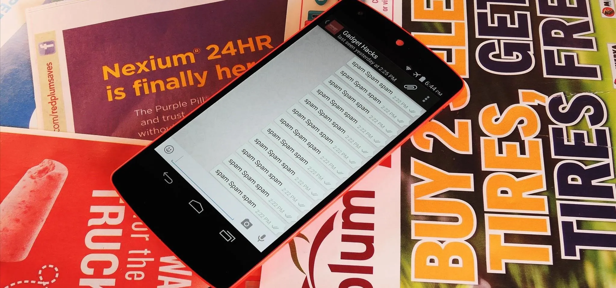 Smartphone displaying a list of items on a colorful background of advertisements.