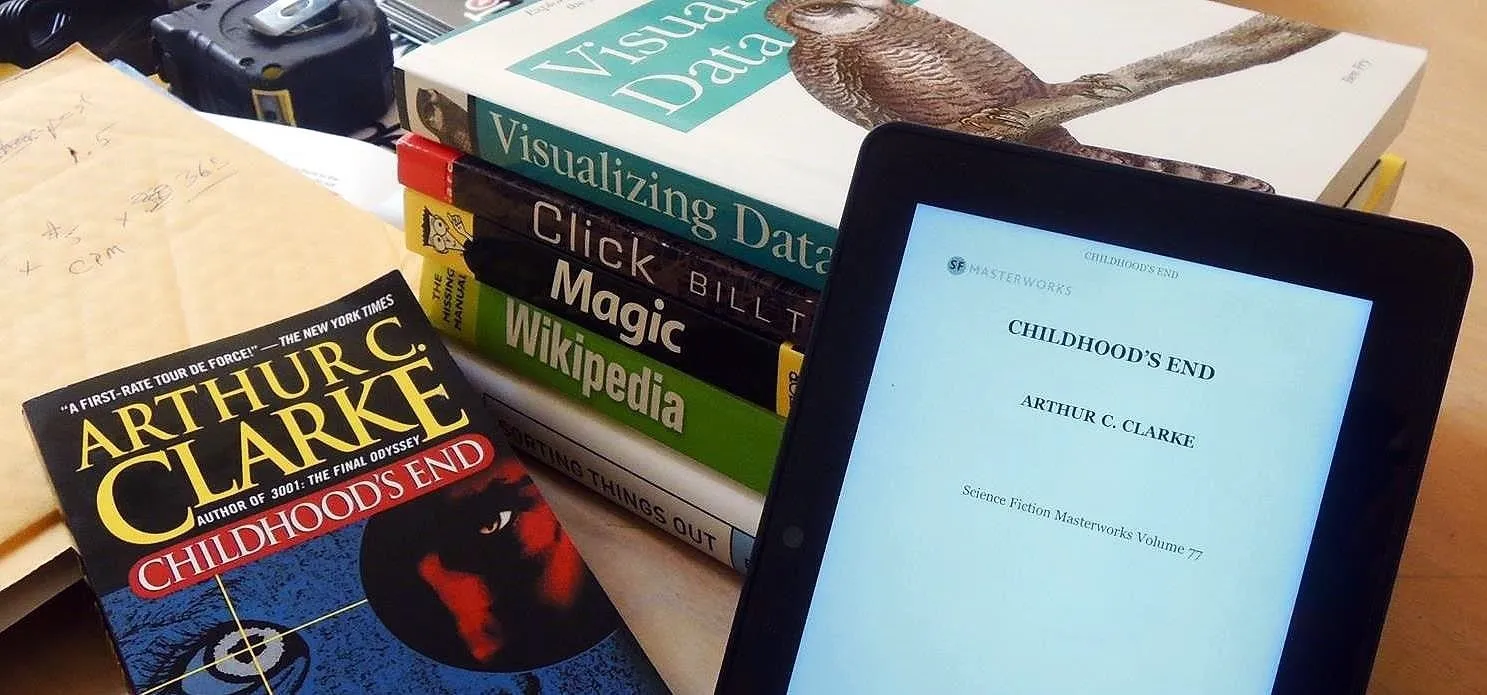 Books and an e-reader displayed on a table.