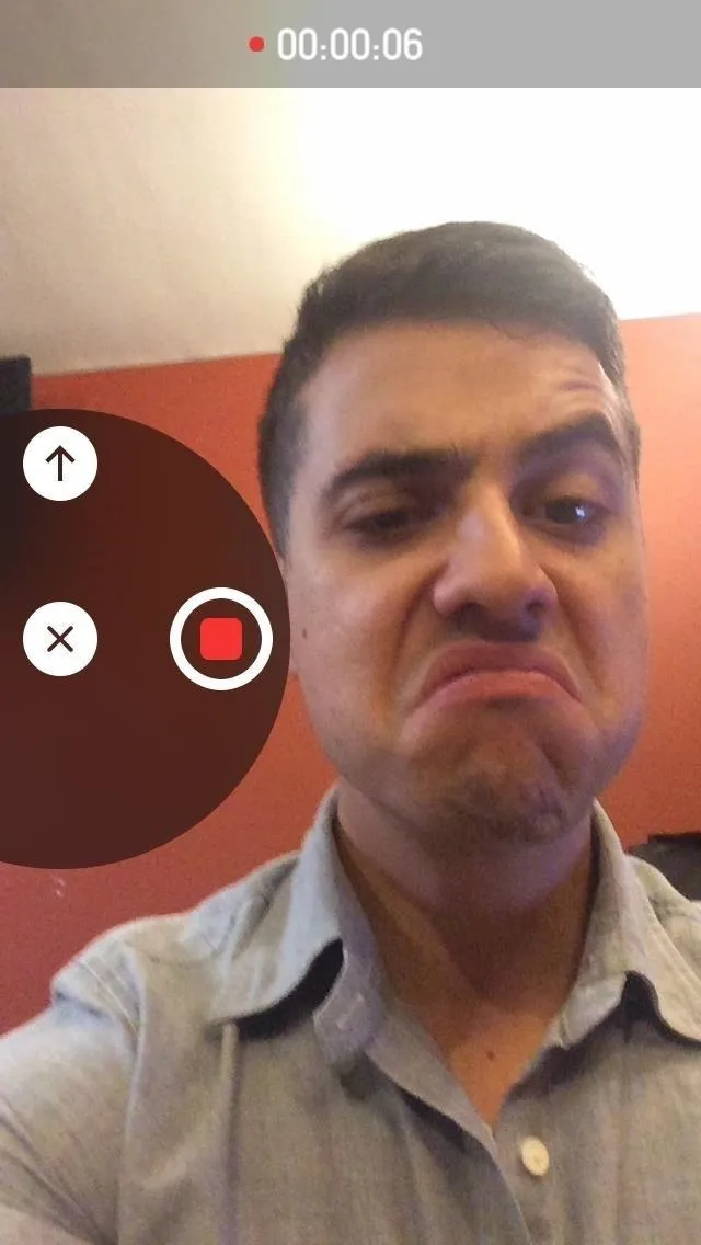 A person making a displeased facial expression while recording a video.