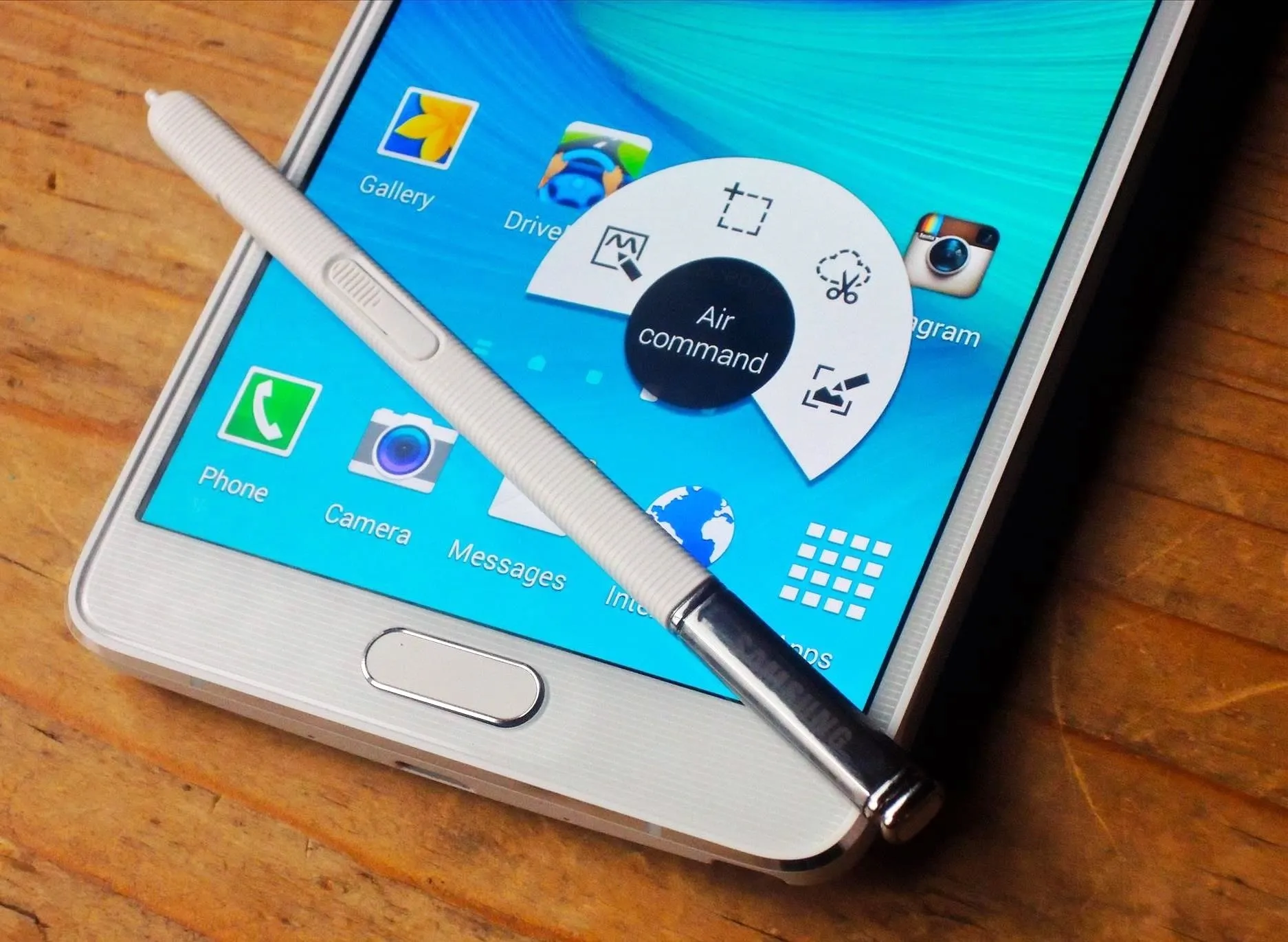 Smartphone with stylus and app menu on the screen.