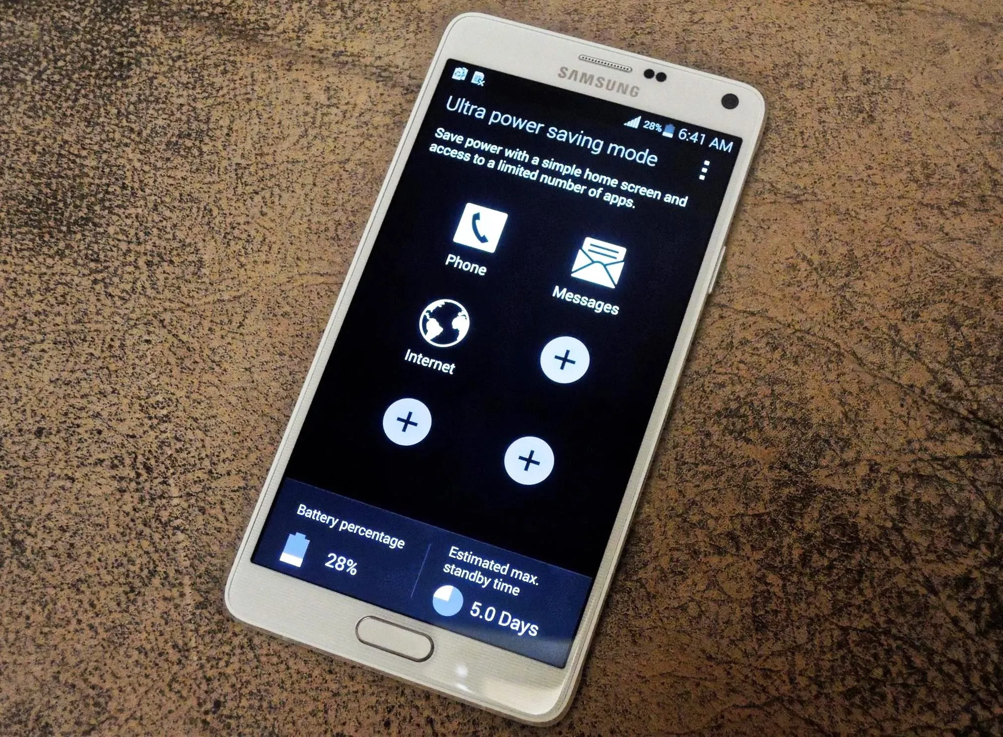 Smartphone displaying power saving mode options on black screen.